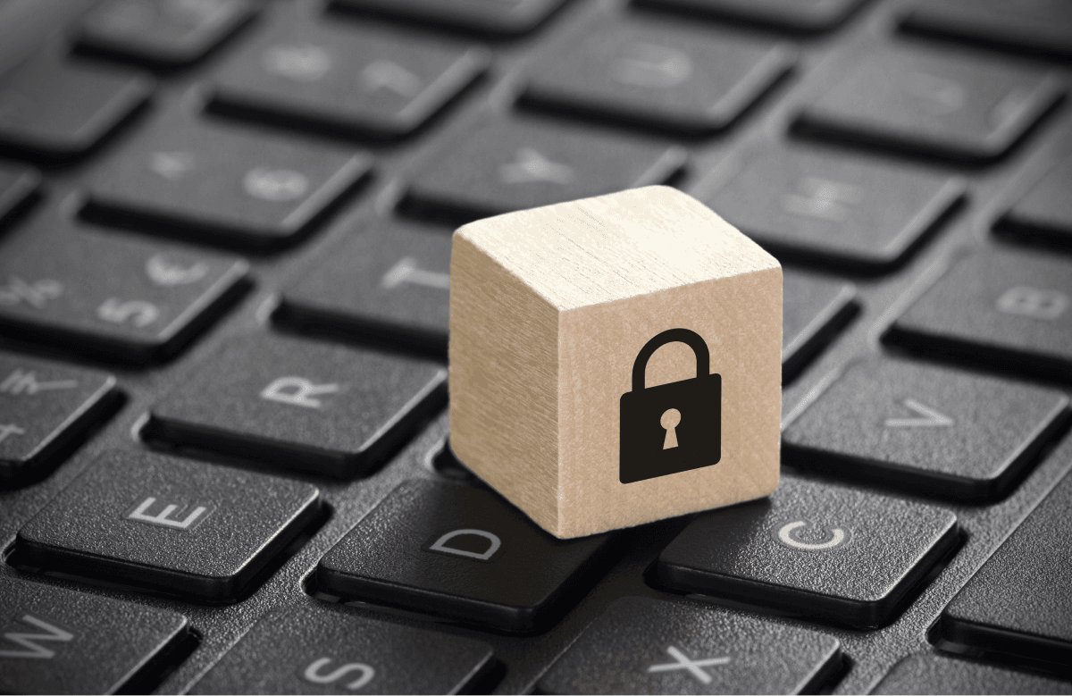 A wooden cube with padlock on a keyboard