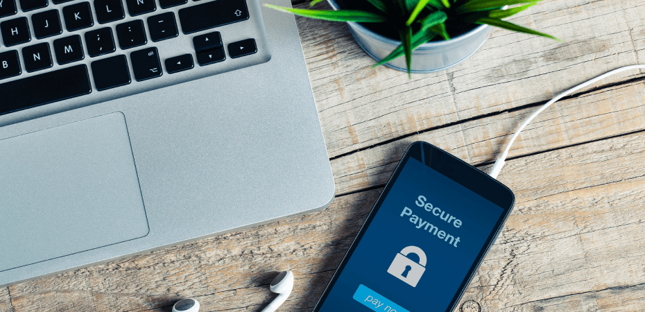 A smartphone on a desk with Secure Payment printed on the screen